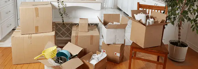 Packed moving boxes and household items in a kitchen before move-out or move-in cleaning, Chattanooga, TN.